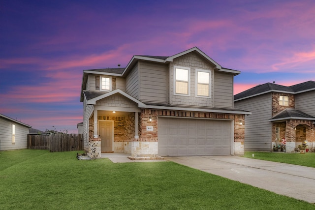 view of front of property featuring a lawn and a garage