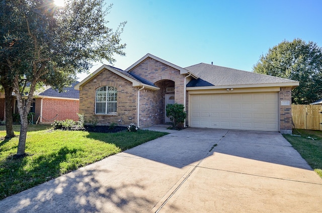 ranch-style house featuring a front yard and a garage