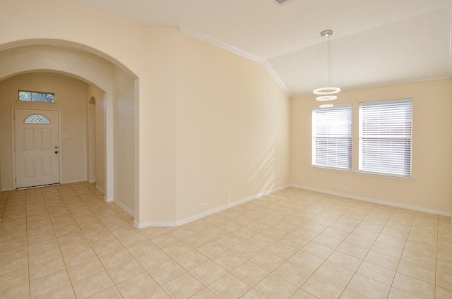 spare room with crown molding, light tile patterned floors, lofted ceiling, and an inviting chandelier