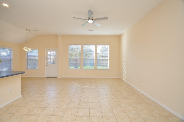 interior space featuring light tile patterned floors, a wealth of natural light, lofted ceiling, and ceiling fan