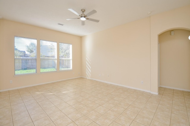 tiled empty room with ceiling fan