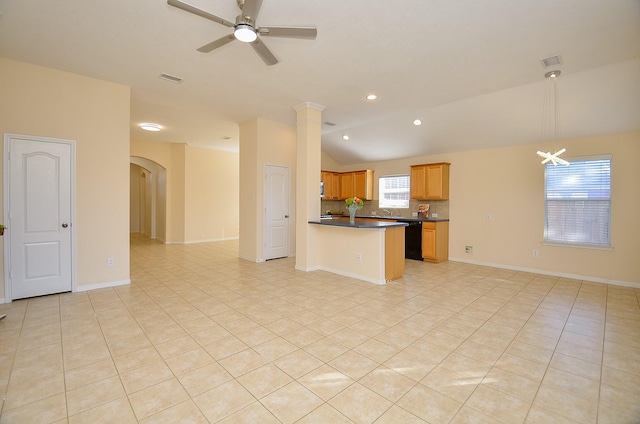 kitchen featuring ceiling fan with notable chandelier, a healthy amount of sunlight, lofted ceiling, and black dishwasher