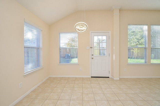 doorway with light tile patterned flooring, a wealth of natural light, and vaulted ceiling