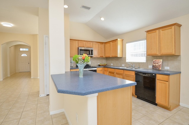 kitchen featuring light brown cabinets, lofted ceiling, decorative backsplash, light tile patterned flooring, and stainless steel appliances