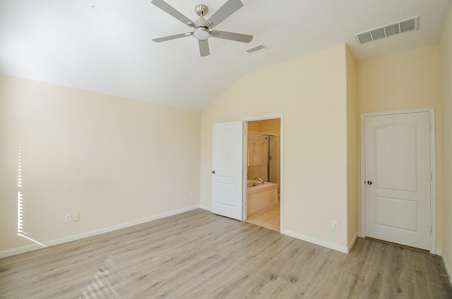 unfurnished bedroom with ensuite bath, ceiling fan, light hardwood / wood-style floors, and vaulted ceiling