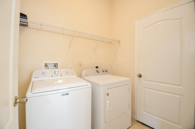 washroom featuring washing machine and clothes dryer and light tile patterned floors