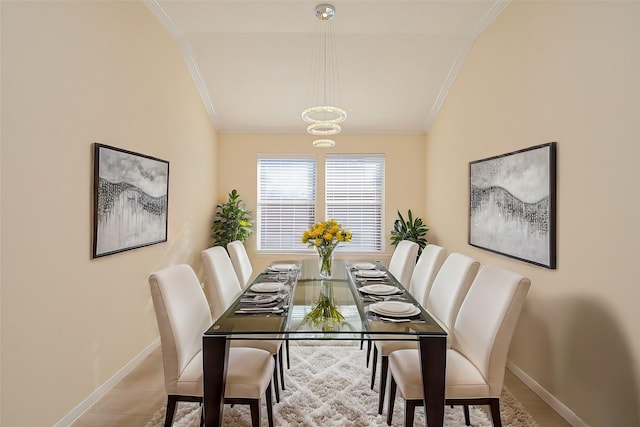 dining room featuring tile patterned floors, lofted ceiling, and crown molding