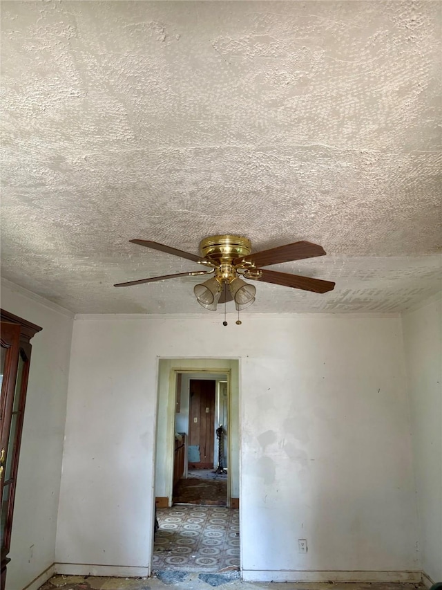 spare room featuring ceiling fan and a textured ceiling