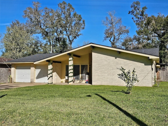 single story home featuring covered porch, a garage, and a front yard