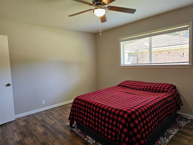 bedroom with dark hardwood / wood-style flooring and ceiling fan