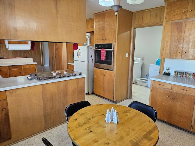 kitchen featuring washer / dryer and appliances with stainless steel finishes