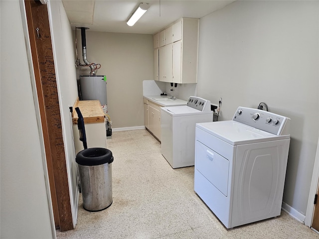 washroom featuring cabinets, separate washer and dryer, sink, and gas water heater