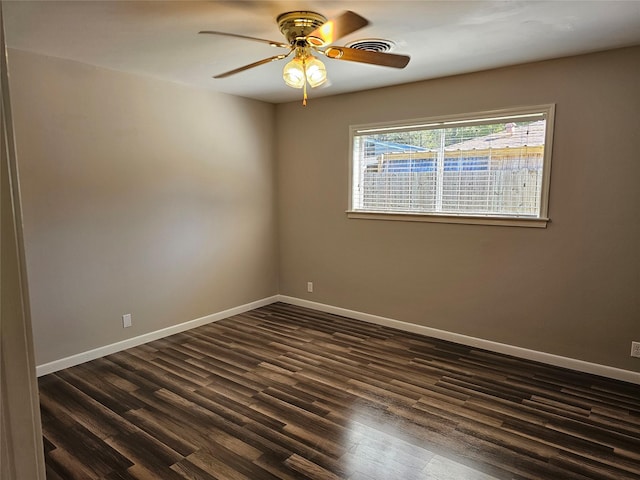 unfurnished room with ceiling fan and dark hardwood / wood-style flooring