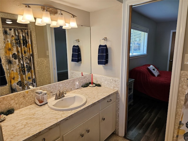 bathroom with wood finished floors and vanity