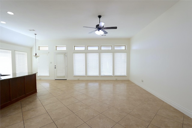 unfurnished room with ceiling fan with notable chandelier and light tile patterned flooring