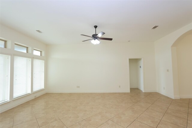 tiled empty room with ceiling fan