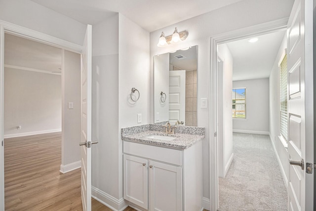 bathroom with hardwood / wood-style floors and vanity