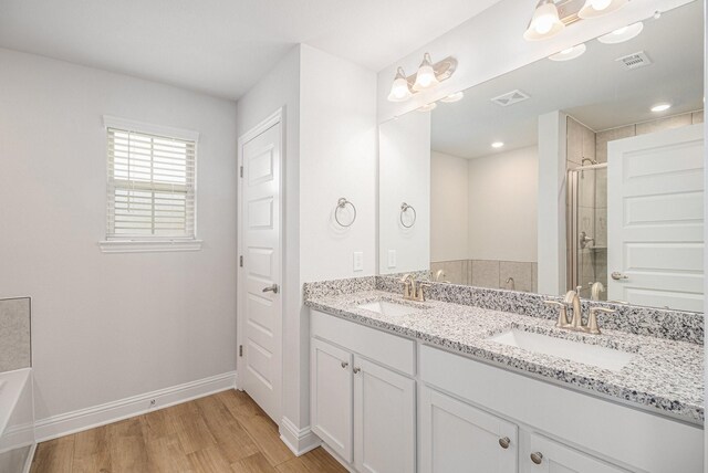 bathroom featuring a shower with shower door, wood-type flooring, and vanity