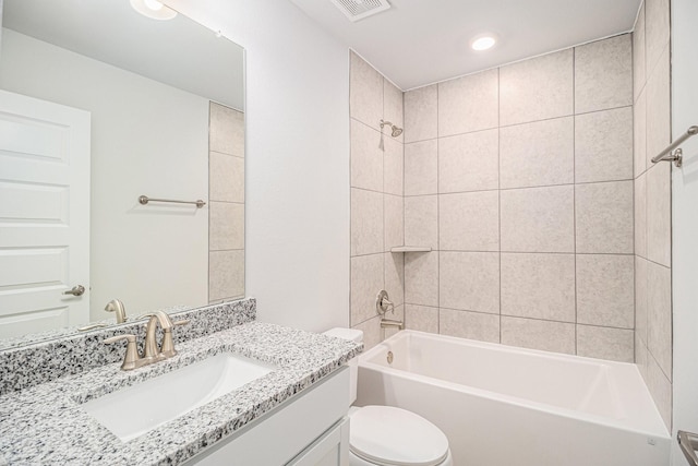 full bathroom with vanity, tiled shower / bath combo, and toilet