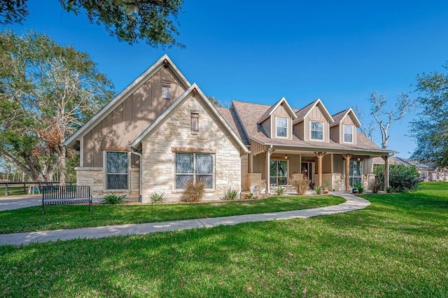 view of front of house with a porch and a front yard