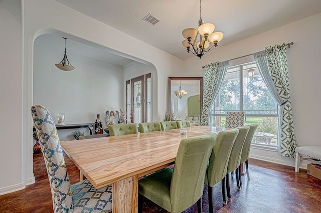 dining room featuring dark hardwood / wood-style flooring and a notable chandelier