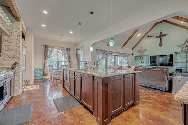 kitchen featuring hanging light fixtures, a center island with sink, a wealth of natural light, and sink