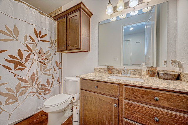 bathroom featuring vanity and toilet