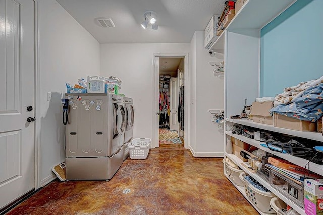 clothes washing area featuring washing machine and dryer