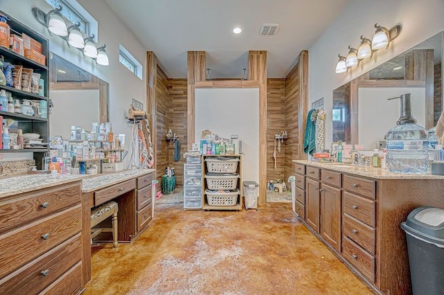 bathroom with vanity, walk in shower, wooden walls, and concrete floors