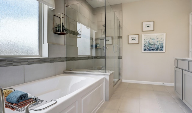 bathroom with tile patterned floors, vanity, and separate shower and tub