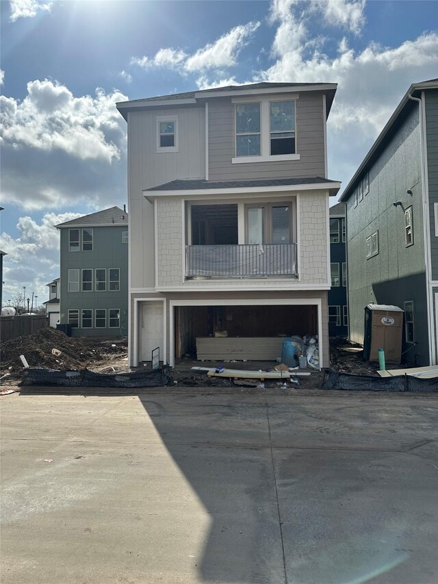 view of front facade with board and batten siding, an attached garage, and concrete driveway