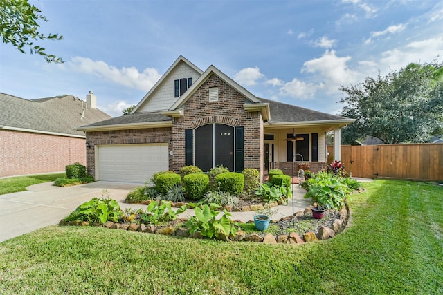 view of front of property featuring a front yard, a garage, and ceiling fan