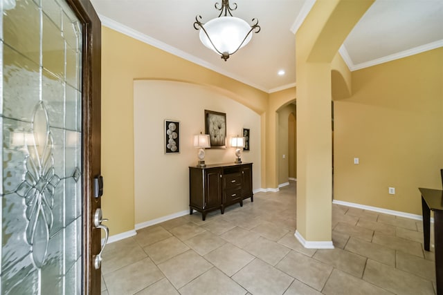 foyer featuring crown molding and light tile patterned flooring