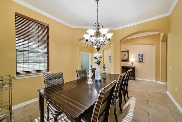 tiled dining room featuring crown molding and an inviting chandelier