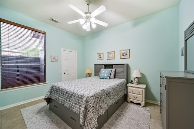 tiled bedroom with ceiling fan