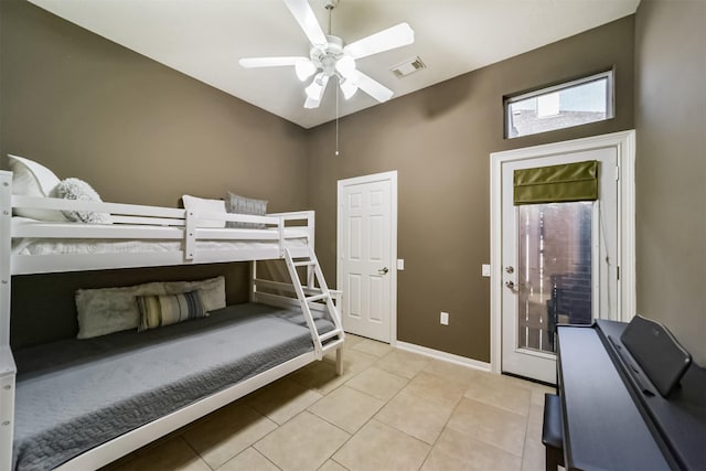 tiled bedroom featuring ceiling fan