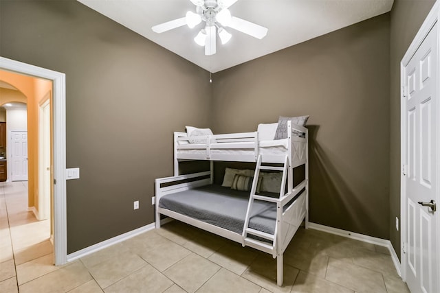 tiled bedroom with ceiling fan