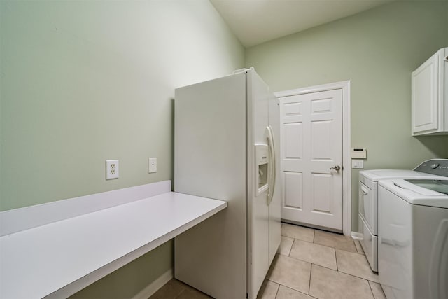 laundry area with cabinets, washer and dryer, and light tile patterned flooring