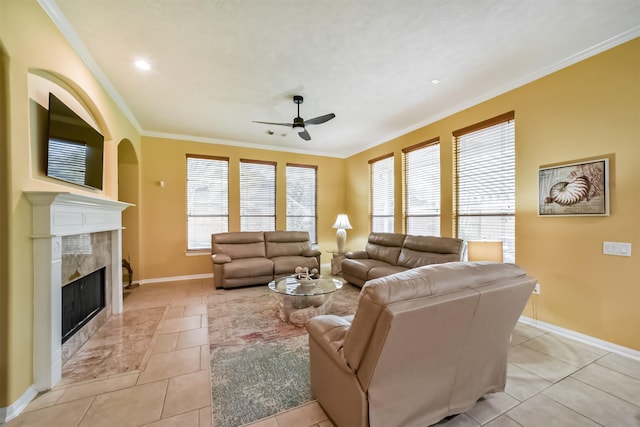 living room featuring a premium fireplace, crown molding, and a healthy amount of sunlight