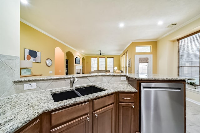 kitchen featuring stainless steel dishwasher, ceiling fan, ornamental molding, and sink