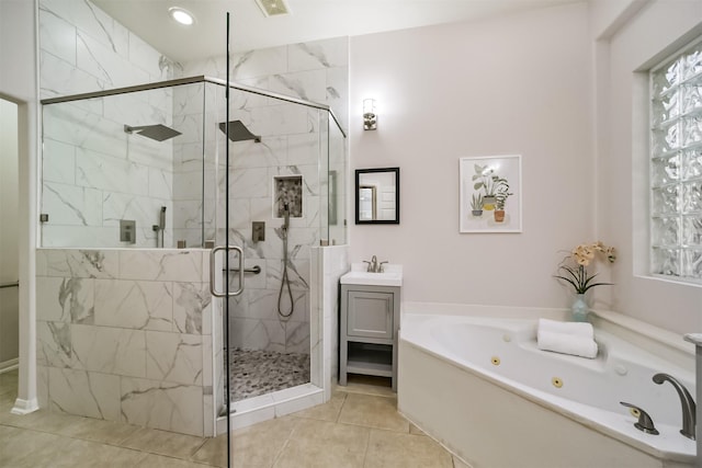 bathroom with tile patterned floors, vanity, and separate shower and tub