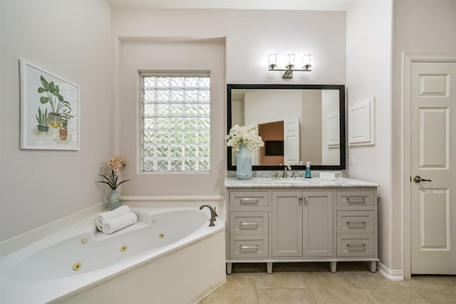 bathroom featuring tile patterned flooring, vanity, and a washtub