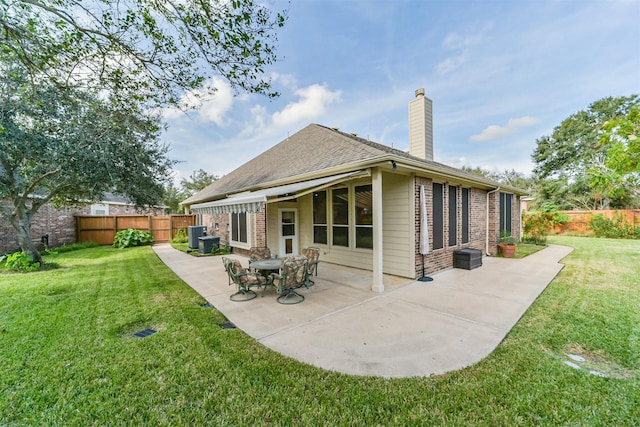 rear view of property with a patio area and a yard