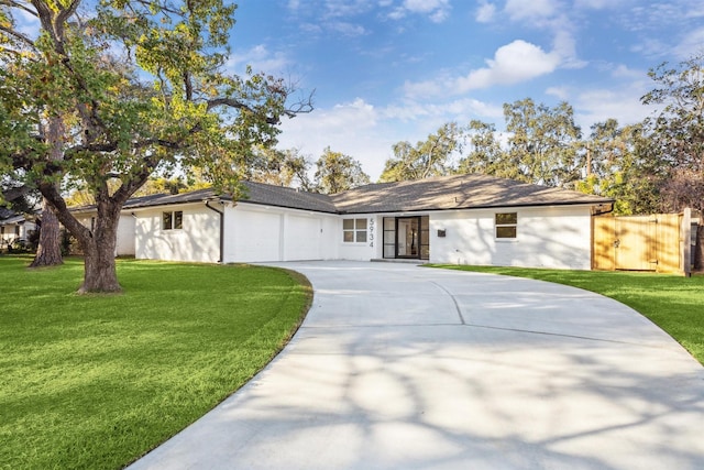 ranch-style home featuring a front yard and a garage