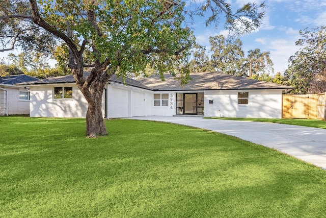 ranch-style house with a garage and a front lawn