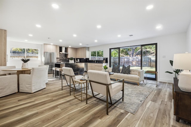 living room with a wealth of natural light and light wood-type flooring