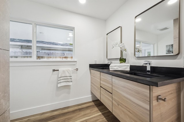 bathroom with hardwood / wood-style flooring and vanity