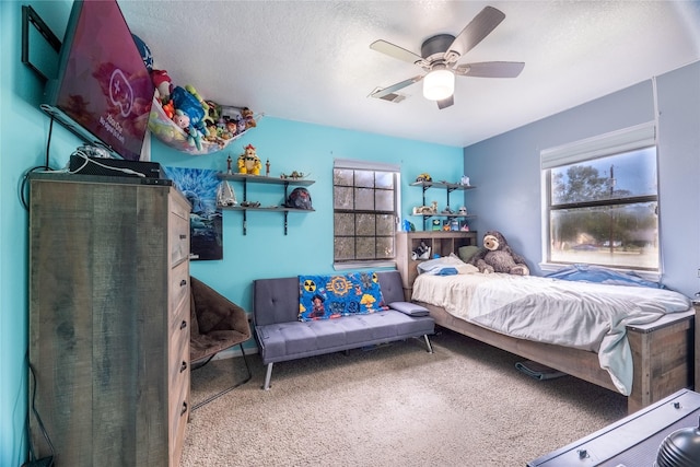 bedroom featuring carpet, a textured ceiling, and ceiling fan