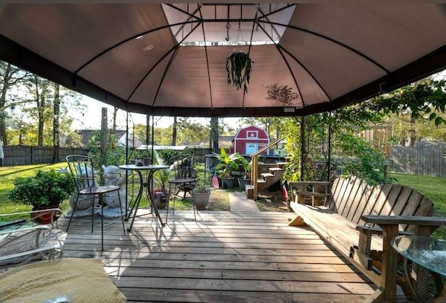 wooden deck featuring a gazebo and a shed