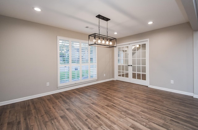 unfurnished dining area with dark wood-type flooring and french doors